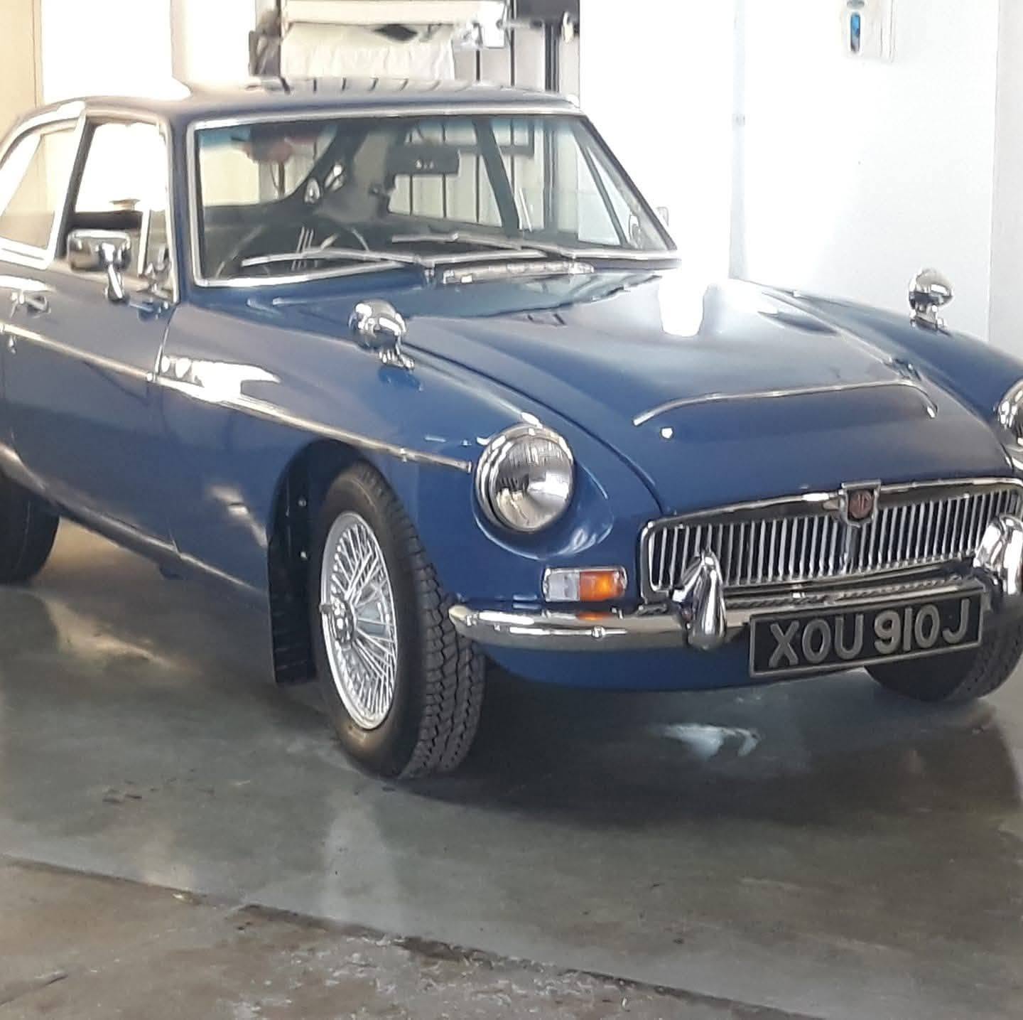 Blue MGB GT indoors