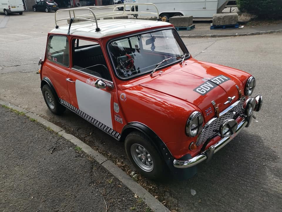 Red Mini with white roof parked at the kerb