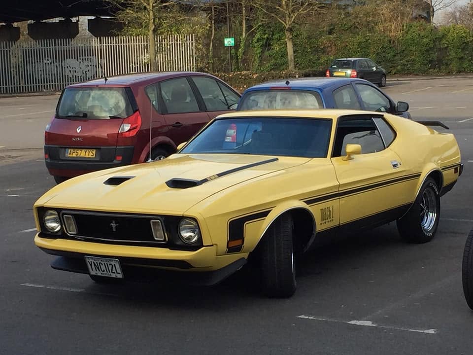 Yellow Ford Mustang Mach 1 in a car park